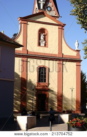 NIEDER-OLM, GERMANY - OCTOBER 14: The forecourt and the exterior facade of the Catholic parish church of St. Georg on October 14, 2017 in Nieder-Olm.
