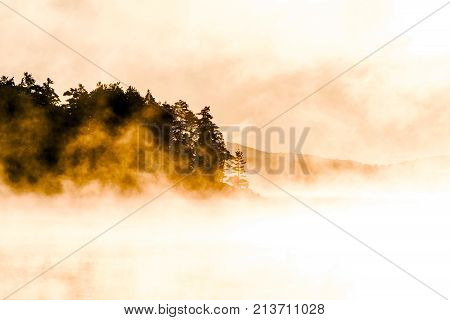 Lake of two rivers in algonquin national park ontario canada sunset sunrise with fog foggy mystical atmosphere background