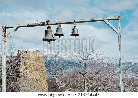 Three Bells And The Ruins Of A Brick Wall Near The Jvari Orthodox Monastery Near Mtskheta, Eastern G