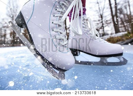 Close-up of woman ice skating on a pond on a freezing winter day