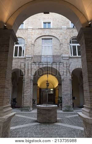 FERMO, ITALY - JULY 9, 2017: Fermo (Marches Italy): historic buildings along an old typical street at evening. Courtyard