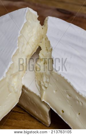 Close Up Of Camembert Cheese. Brie With Coarse Edge Broken Into Pieces Cremy And Delicious.