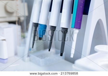 Be sure. Sophisticated modern equipment hanging on special shelf which standing on the desk and waiting for being used