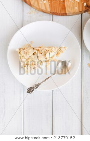 Portion of classic Napoleon cake top view. Traditional millefeuille dessert with puff pastry and custard, russian cuisine treat, copy space