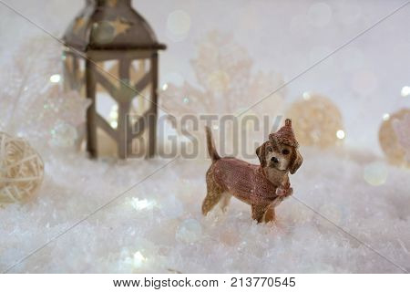 New Year card with toy dog in a fairy forest on winter background with snow and lights. Template greeting card