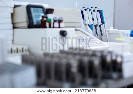 Laboratory environment. Shining new modern equipment located in the lab while medical markers are in focus and situated behind other stuff