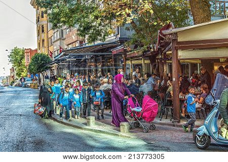 ISTANBUL TURKEY: Children returning from the school near popular street cafe in Cihangir quarter Beyoglu district on October 6 2017