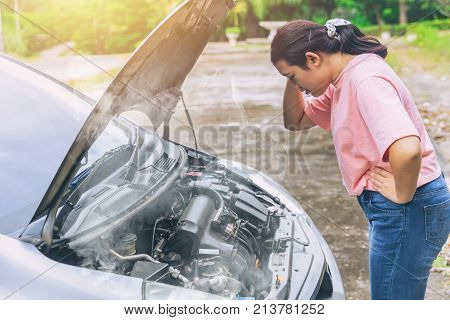 asian women worry and stress a trouble with car engine crash overheat