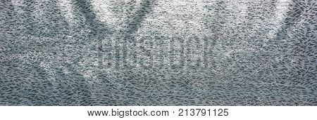Silver fabric brocade. Beautiful textile backdrop. Close-up. Top view