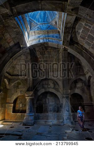 HAGHPAT MONASTERY, ARMENIA - 01 AUGUST 2017: Young woman enjoying natural light effects inside Haghpat Monastery on Northern Armenia