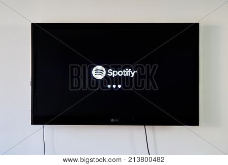 MONTREAL CANADA - NOVEMBER 15 2017: Spotify logo and app on LG TV screen. Spotify is a music podcast and video streaming service that was officially launched on 7 October 2008.