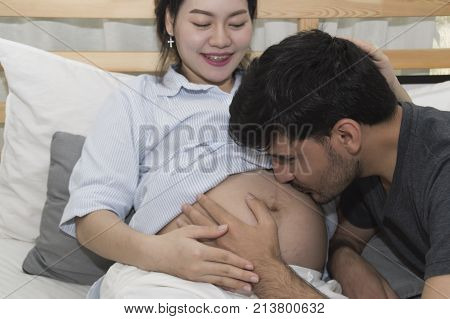 The man and pregnant woman are doing home activities.