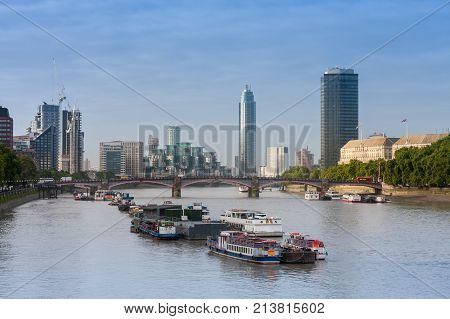 City cruise ships on the river Thames, on background Lambert Bridge and London Towers in the morning, London, England.