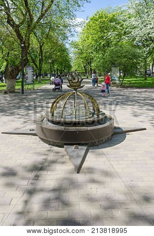 POLOTSK BELARUS - MAY 19 2017: Unknown people walk in park on Francisk Skaryna Avenue near memorial sign 