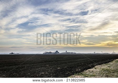 agriculture arable land field with sky clouds. agricultural landscape
