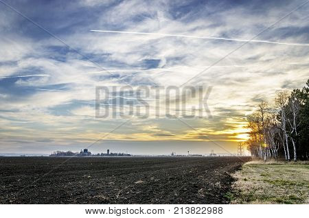 agriculture arable land field with sky clouds. agricultural landscape