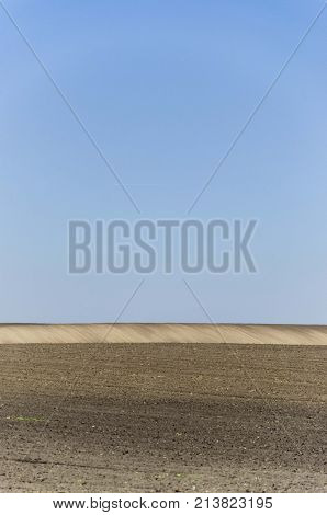agriculture arable land field with sky clouds. agricultural landscape