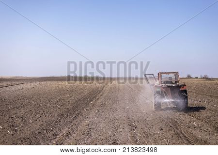 arable land landscape with tractor machine working