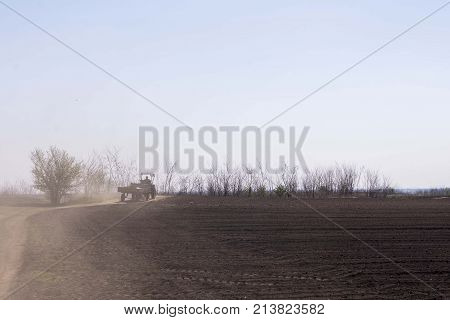 arable land landscape with tractor machine working