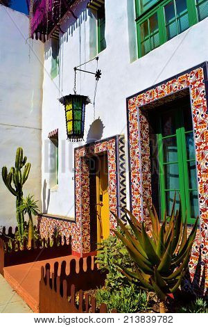Spanish style building with a colorful contemporary architectural design surrounded by a drought tolerant cacti garden