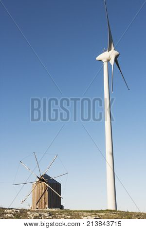 Rare and traditional Portuguese windmill built in wood with the particularity to turn on itself to capture wind side by side with a modern windmill to produce eolic energy