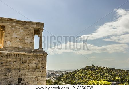 close-up view of the buildings of the Acropolis and behind the monument to Philopappos on the hill of the same name athens