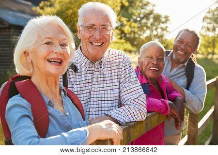 Portrait Of Senior Friends Hiking In Countryside