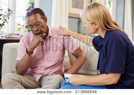 Support Worker Visits Senior Man Suffering With Depression