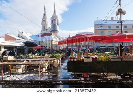Zagreb, Croatia: January 7 2016: Stand With Red Parasols At Dolac Market During Wintertime With Snow