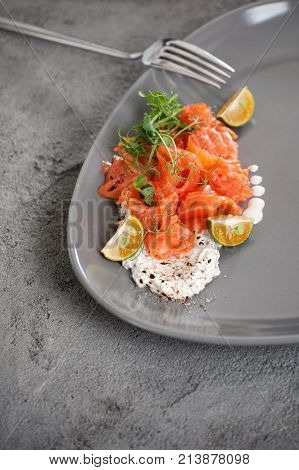 Slightly Salted Salmon With Cream Cheese And Limequat On A Gray Concrete Table..