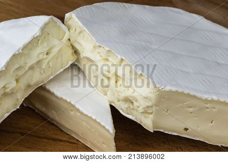 Close Up Of Camembert Cheese. Brie With Coarse Edge Broken Into Pieces Cremy And Delicious.