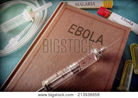 Vintage Syringe On A Book Of Ebola, Medical Concept