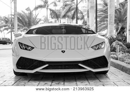 Miami Florida USA-February 19 2016: Supercar Lamborghini Aventador orange color parked next to Ocean drive at South bech at Miami Florida. Lamborghini is famous expensive automobile brand car