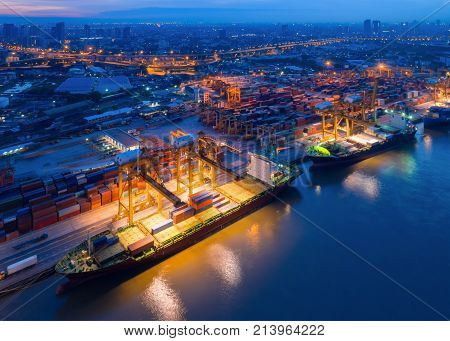 Containers yard in port congestion with ship vessels are loading and discharging operations of the transhipments in international port.