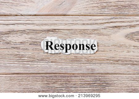 RESPONSE of the word on paper. concept. Words of RESPONSE on a wooden background.