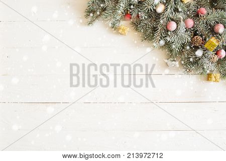 Fir Branch With Christmas Decorations On The White Wooden Table Or Plank Background