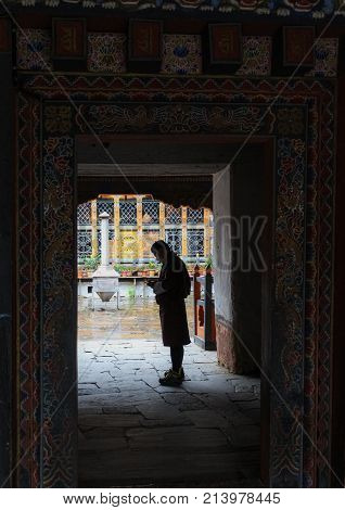 Trongsa, Bhutan - September 13, 2016: Bhutanese Man In Traditional Dress Standing At The Doorway In