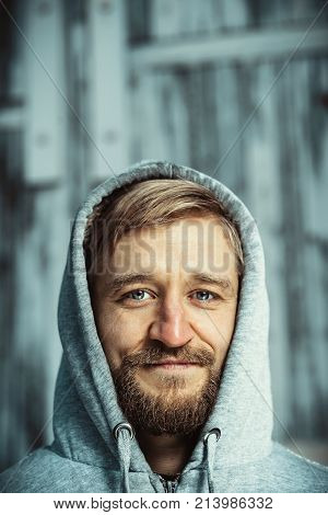 Young man with a beard and mustache outdoor portrait
