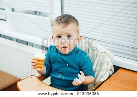 Baby In The Kitchen Eagerly Eating The Delicious Cream Horns, Vanilla Cream