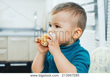 Baby In The Kitchen Eagerly Eating The Delicious Cream Horns, Vanilla Cream