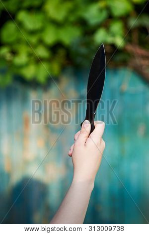 Black Knife For Throwing In The Hand Of A Woman, Game For Active Recreation