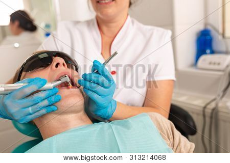 Treatment Of Caries. A Dentist Treats The Patients Teeth For Pulpitis. Periodontitis Of The Teeth.