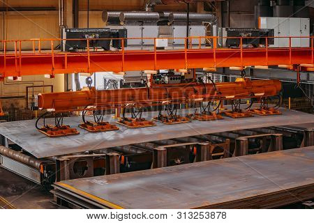 Overhead Crane With Vacuum Handling Grippers Lifting Iron Sheets.