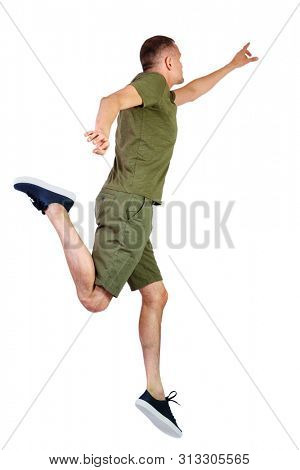 Back view of pointing man in zero gravity or a fall. guy is flying, falling or floating in the air.  Isolated over white background. The guy in shorts and sneakers in a jump is trying to reach 