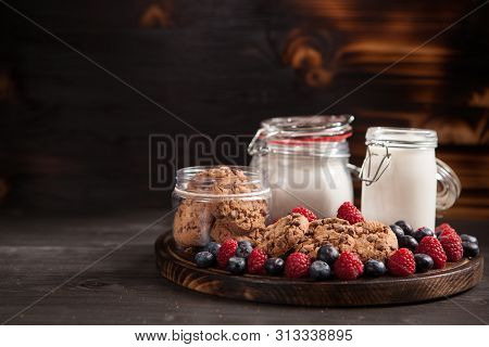 Homemade Biscuits With Bluebarries And Fresh Milk Over A Rustic Wooden Table
