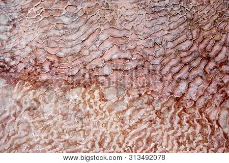 Undulatory Texture Of White Calcite Stalactites Covering A Cascade Of Terraced Baths In Pamukkale, T