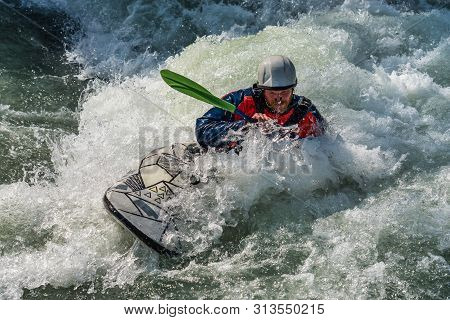 Augsburg, Germany - June 16, 2019: Whitewater Kayaking, Extreme Kayaking. A Guy In A Kayak Sails On 