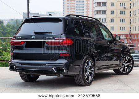 Novosibirsk, Russia - 07.20.2019: Black New Bmw X7 Xdrive40i 2019 Year Rear View With Lifht Gray Int