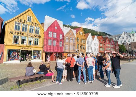 Bergen, Norway - July 28, 2018: Tourists In Front Of The Historical Buildings In Bryggen- Hanseatic 