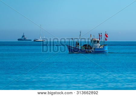 Fishing Boat With Red Flags On The Baltic Sea Near Heiligendamm And Kuehlungsborn